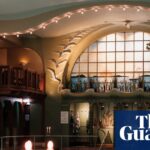 Swimmers in Centralbadet's ornate Art Nouveau pool, lit candles and stained-glass window