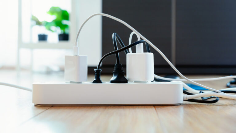 Multiple devices plugged into a single surge protector power strip.